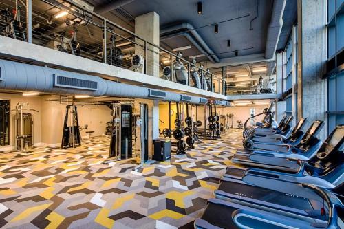 a gym with a bunch of exercise bikes in it at City & River View Suite - The Wharf DC by Monthier in Washington, D.C.