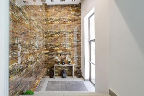 a brick wall in a hallway with a table at Olympia Hotel by Lodgo in Montréal