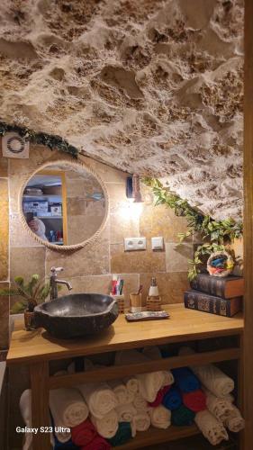 une salle de bain avec un lavabo et un miroir dans l'établissement Le Château de Soleil, à Saint-Pons-de-Mauchiens
