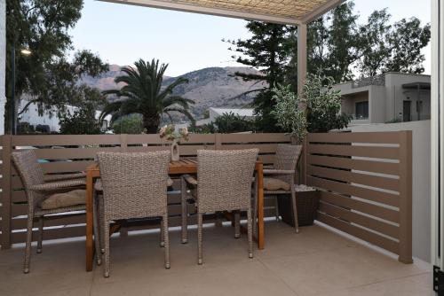 a wooden table and chairs on a patio at HESTIA frontyard Georgioupolis in Georgioupolis