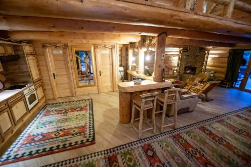 a kitchen and living room of a log cabin at Villa Bosnia in Donji Vakuf