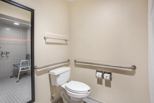 a bathroom with a toilet and a shower at Best Western Luxury Inn in Tracy