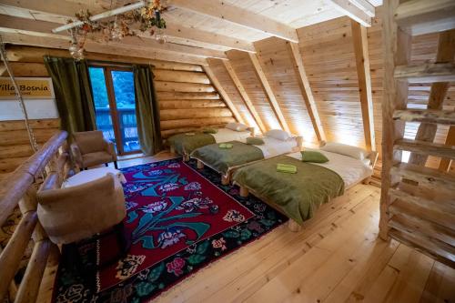 a room with four beds in a log cabin at Villa Bosnia in Donji Vakuf
