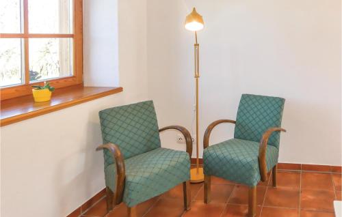 two chairs sitting next to a lamp in a room at Ferienwohnung In Limbach in Limbach im Burgenland