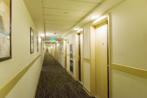 a hallway of a hospital with a long aisle at Jinjiang Inn - Shanghai Nanxiang in Jiading