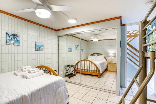 a bedroom with a bed and a room with a bed at Beachfront Penthouse with 3 Lanais on Oahu! in Hauula