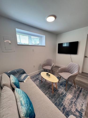 a living room with a couch and a table at Perfect Vancouver Travel Hub for Couples or Family in Vancouver