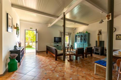 a living room with a table and chairs at Natur - Quinta Nª Srª da Conceição - T4 - Golegã in Golegã