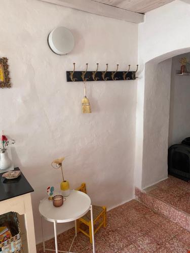 a room with a white table and a table and a table at Casa na aldeia in Albernoa