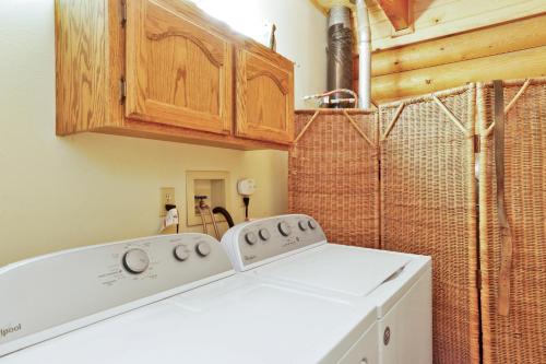 a laundry room with a white washer and dryer at Knotty and nice #177 in Big Bear Lake