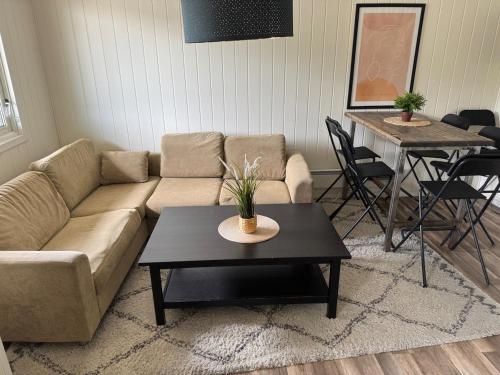 a living room with a couch and a table at LettvintHytta Kvitfjell Vest Linens included in Kvitfjell