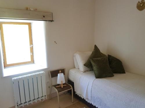 a small bedroom with a bed and a window at The Mill France- Near Millau in Saint-Georges-de-Luzençon