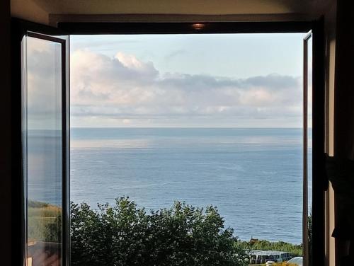 a view of the ocean from a window at Vista Horizonte in Salga