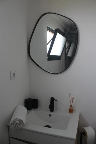 a bathroom with a mirror above a white sink at Vista Horizonte in Salga