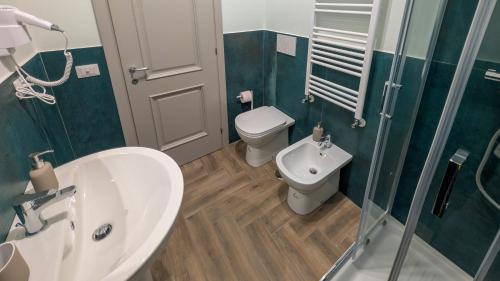 a bathroom with a sink and a toilet and a shower at Conca D'Oro Guest House - Elisabetta in Rome