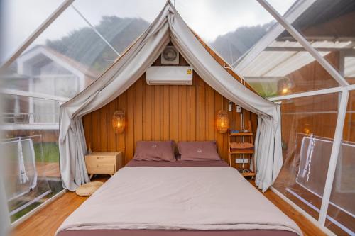 a bedroom with a bed in a tent at เต็นท์ดูดาว1 แอร์ ม่อนแจ่ม วิวดอยหลวงเชียงดาว in Mon Jam