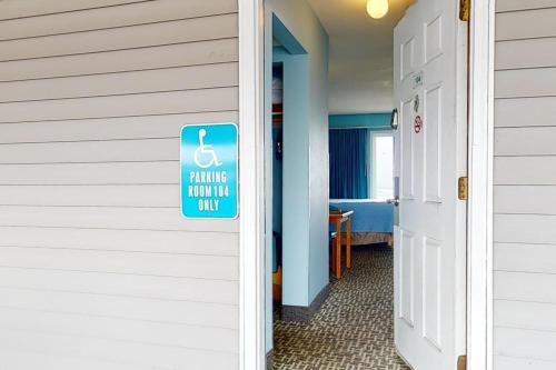 a sign on the side of a building with a handicapped sign on it at Oceanfront Studio - Sleeps 4 - Ground Floor - Pool and Hot Tub in Lincoln City