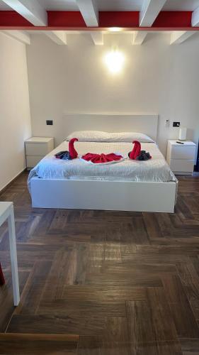 a large bed in a room with a wooden floor at Casa Borgata in Grondona