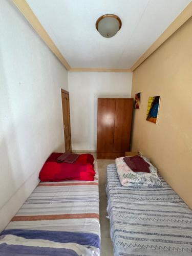 a room with two beds in a room at Rooms in Granada
