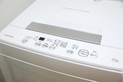 a close up of a washing machine with buttons at Shirogane Apartment in Tokyo