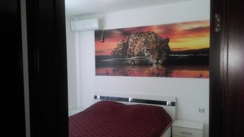 a painting of a leopard on the wall of a bedroom at Black & White in Burgas