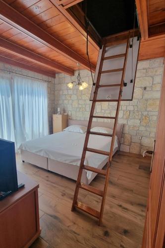a bedroom with a ladder leading to a bed at Seaside house with a swimming pool Vinjerac, Zadar - 9689 in Vinjerac