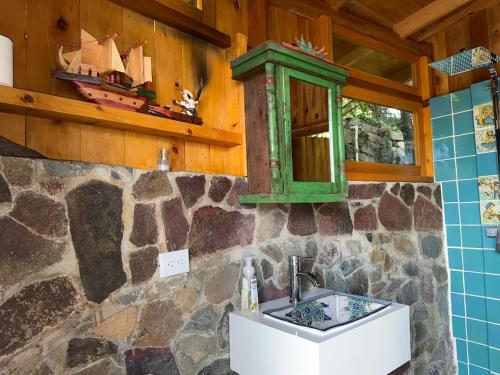 a bathroom with a green cabinet above a sink at 2-story Lakefront castita, beach, kitchen, sauna in Sololá