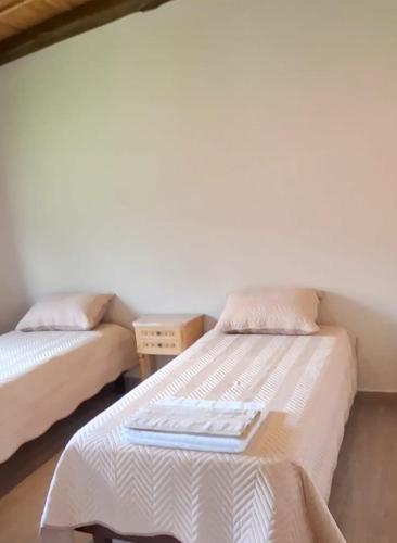 a bedroom with two beds with a tray on it at Barcena Houses in Tumbaya