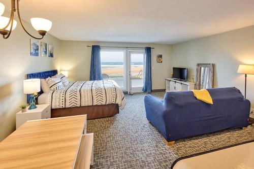 a bedroom with a bed and a couch at Beachfront Studio - No Stairs - Patio - Full Kitchen in Lincoln City