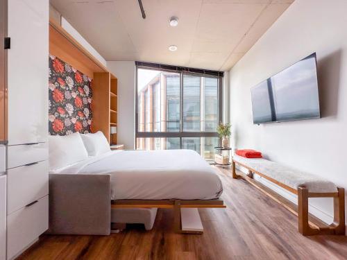 a bedroom with a large bed and a window at River & City View Suite - The Wharf DC by Monthier in Washington, D.C.