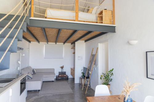 a living room with a couch and a boat on the ceiling at Casa Nook Sagres in Vila do Bispo