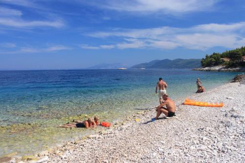 a group of people laying in the water at the beach at Holiday house with a parking space Blato, Korcula - 24736 in Blato