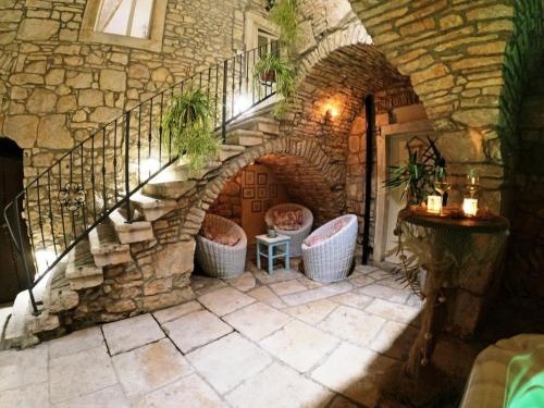 a stone stairway with wicker chairs on a patio at Holiday house with a parking space Blato, Korcula - 24736 in Blato