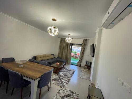 a living room with a table and a couch at Gaia - Ras Elhekma- North coast in Zāwiyat al ‘Awwāmah