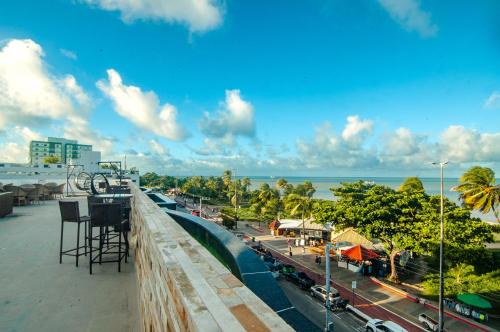 a view of the ocean from the balcony of a resort at Flat de frente à praia in João Pessoa