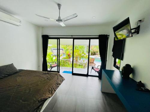 a bedroom with a bed and a view of a patio at Surya Villa in Ko Phangan