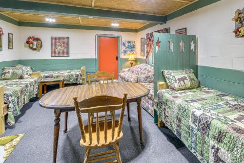 a room with a table and two chairs and a table at ATV Escape Near Hatfield-McCoy Trails in Matewan! 