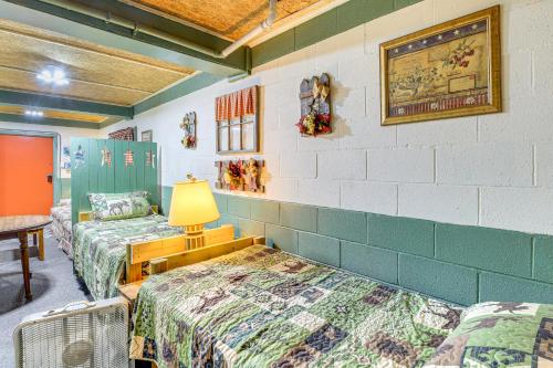 a room with two beds and a lamp in it at ATV Escape Near Hatfield-McCoy Trails in Matewan! 