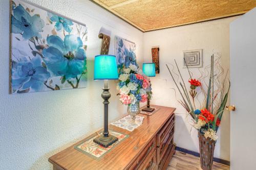 a table with a lamp and flowers on it at ATV Escape Near Hatfield-McCoy Trails in Matewan! 