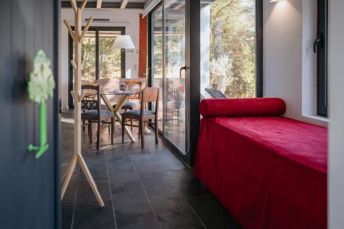 a living room with a red couch and a table at Casa Malcata by Portus Alacer - Quinta Fonte Fria in Carreiras
