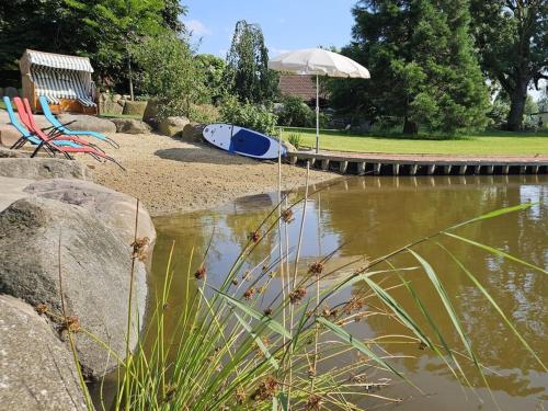 a surfboard laying on the shore of a pond at Country house apartment 