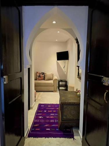 a hallway leading to a living room with a couch at Dar Larbi in Chefchaouene