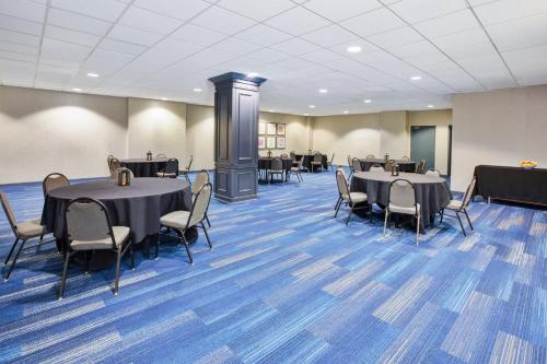 a meeting room with tables and chairs in a building at Holiday Inn Express Nashville-Downtown - Broadway by IHG in Nashville