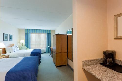 a hotel room with two beds and a bathroom at Holiday Inn Manahawkin/Long Beach Island by IHG in Manahawkin