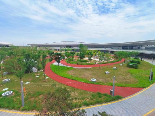 an aerial view of a park in front of a building at Wanda Jin Xiaohe Xincheng in Taiyuan