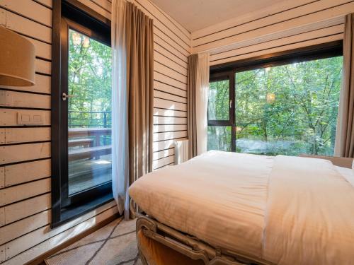 a bedroom with a bed and a large window at Cottage in Tournai with Forest View in Antoing
