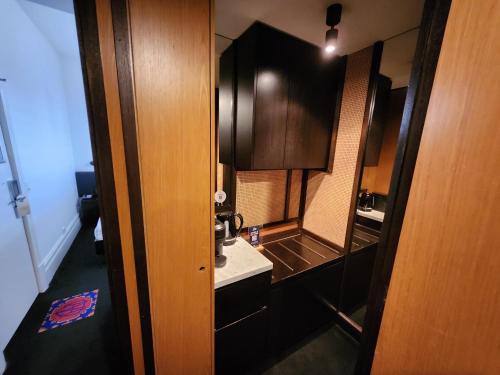 a small bathroom with a sink and a mirror at Middle Park Hotel in Melbourne