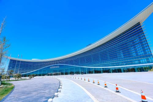 a large building with orange cones in front of it at Wanda Jin Xiaohe Xincheng in Taiyuan