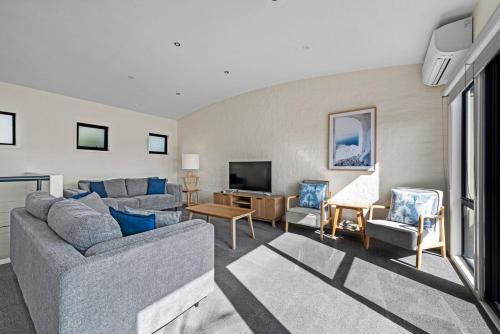 a living room with a couch and chairs and a tv at Perfect Jervis Bay location & fresh modern living in Vincentia