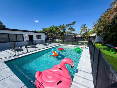 a swimming pool with a pink rubber duck in it at The LuxeLanding MIA- Swimming pool, Oasis Lounge, Mini Golf, BBQ and Hibachi Grill , and Outdoor Games in Miami